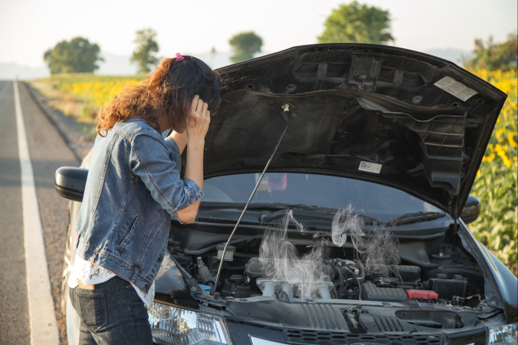 Female with a busted car engine
