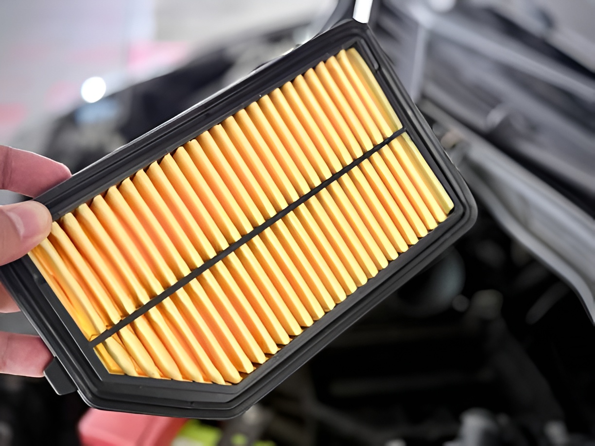 close-up of a man holding a new car air filter